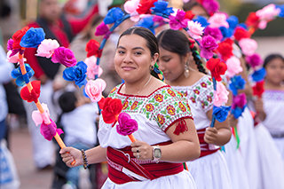 young dancers in traditional costumes performing before the attendees